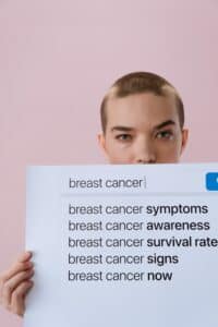 Featured image showing a woman holding a sign with multiple browser searches related to breast cancer, including mammography, breast cancer screening, early detection, breast ultrasound, dense breast, mammogram cost, and mammogram guidelines.